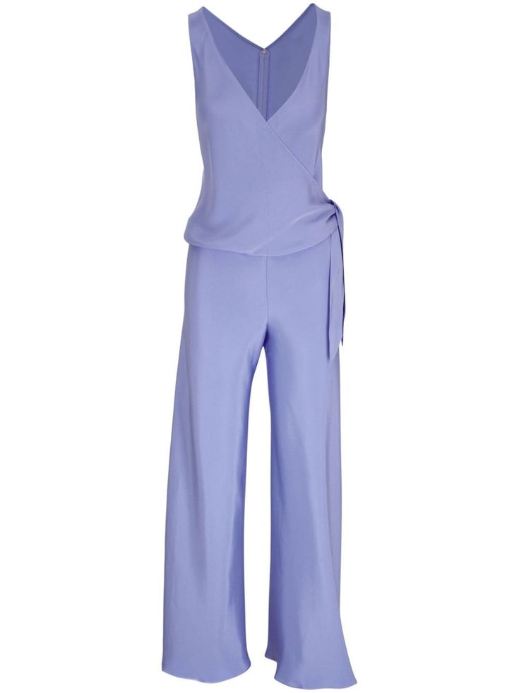 a light purple sleeveless jumpsuit with a wrap bodice and wide legs. the jumpsuit is made of a silky fabric and has a flowy, elegant look. it is a great option for a summer evening out.  the model is wearing a light purple sleeveless jumpsuit with a wrap bodice and wide legs. the jumpsuit is made of a silky fabric and has a flowy, elegant look. the model is looking straight ahead with a neutral expression. the jumpsuit is a great option for a summer evening out.