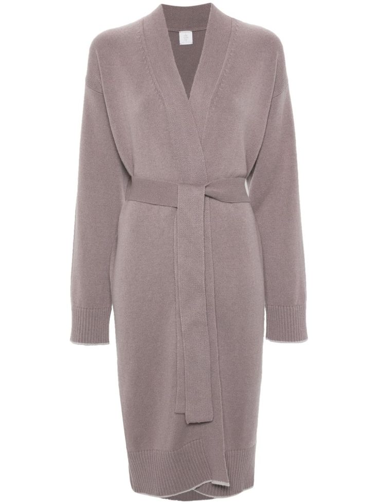a mauve colored, longsleeved, knit cardigan that has a shawl collar, is wrapped, and comes down to just above the knee. it has a selftie waist sash. the cardigan is made from a soft and cozy cashmere fabric and is perfect for lounging around the house or for a casual day out.
