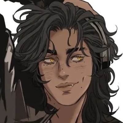 a digital art image of a male cartoon character with dark long hair, tan skin, yellow eyes, freckles under his eyes, headphones around his neck, and a dimple in his cheek. he is smirking slightly and has one visible fang. he is wearing a jacket and part of another person's shadow is visible on the side.
