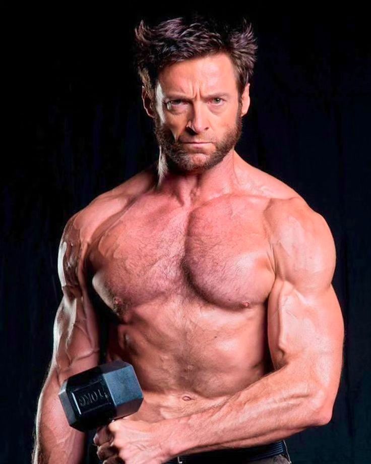 a shirtless hugh jackman, known for his role as wolverine, intensely stares at the viewer while holding a dumbbell in his right hand. he is wellmuscled with prominent biceps, triceps, and chest muscles. he has a full beard and a determined expression. the background is black, emphasizing his physique and creating a dramatic effect.