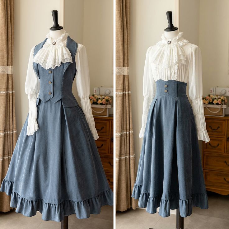 two identical blue vintage style dresses are shown on dress forms, one with the skirt spread out and the other with the skirt gathered. the dresses are styled with white blouses and ruffled collars. the background features a white wall, lace curtains and wooden furniture.