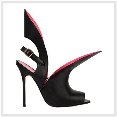 the image showcases a single, black, highheeled women's shoe. the shoe has a unique design; it's a peeptoe stiletto with a dramatically sculpted upper that resembles a wing or a stylized flap, featuring a contrasting vibrant pink inner lining.  the shoe is sleek, modern, and has a striking, unconventional aesthetic. the overall style could be described as avantgarde or high fashion. the heel is thin and very tall, emphasizing its elegance and sophistication.