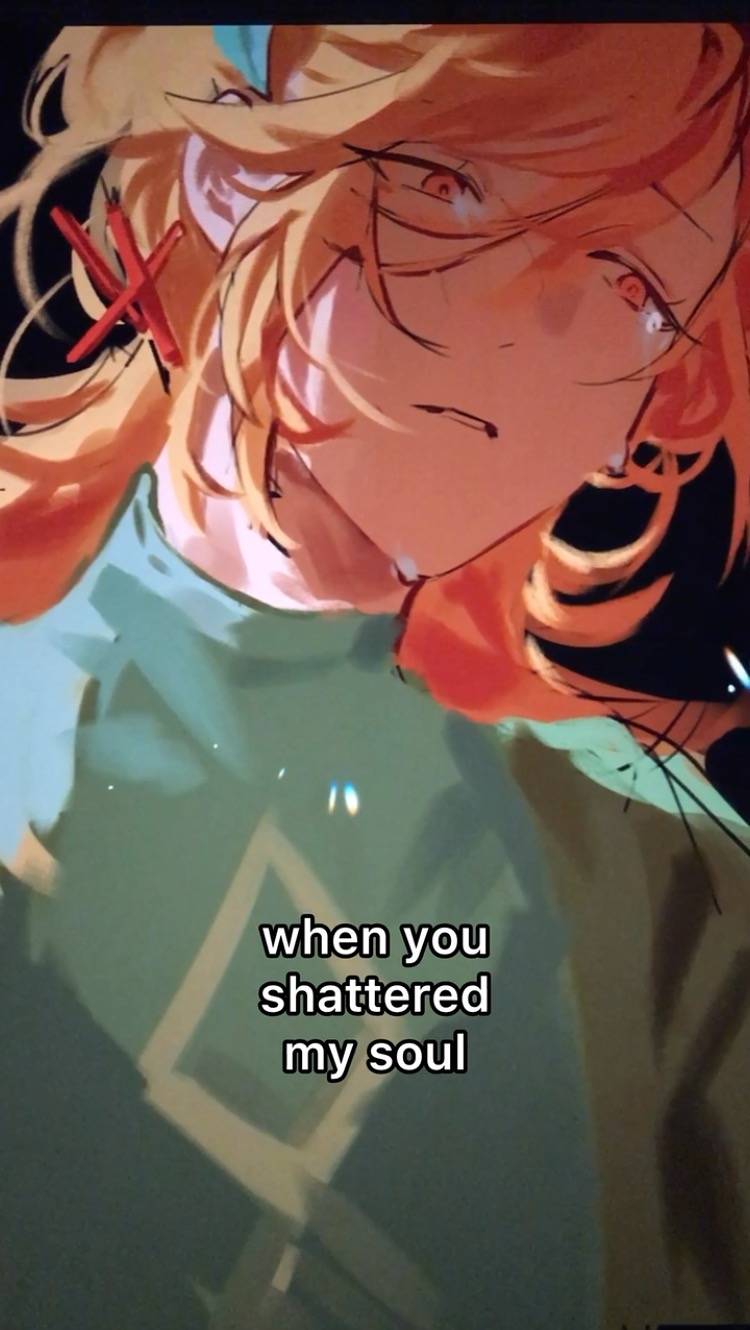 the image is a digital drawing of an anime character. they are a young person with long, flowing orange hair. they are crying and have a pained expression on their face. they are wearing a green shirt. the background is blurry and has some white sparkles. the text says: "when you shattered my soul". the image is an artistic representation of heartbreak and emotional pain.