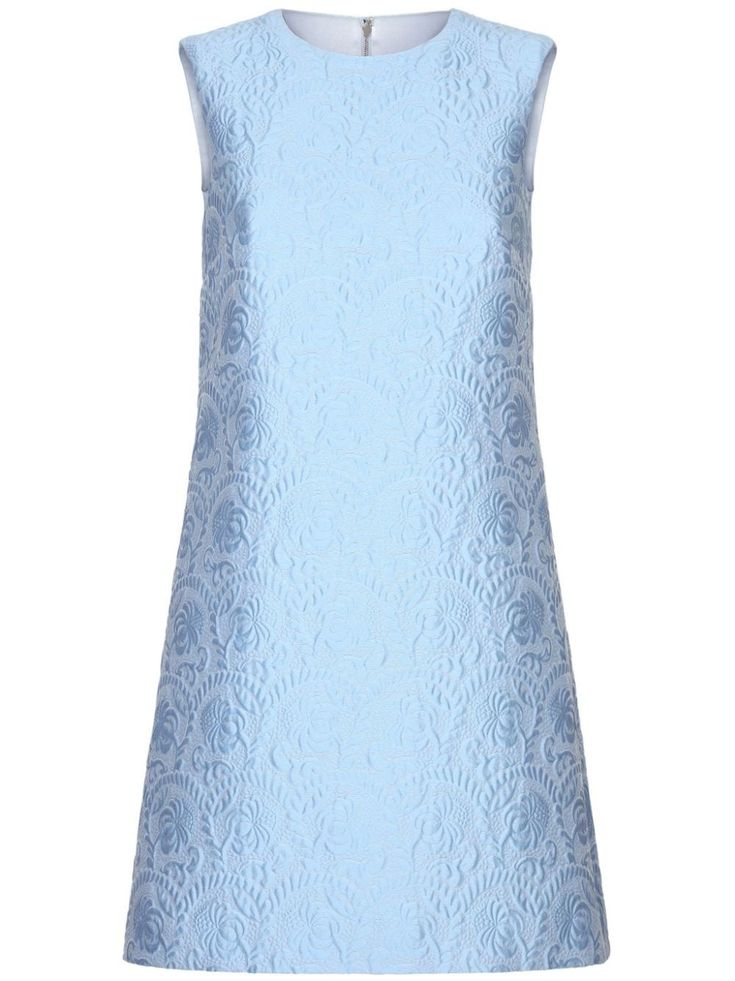 a light blue, sleeveless, floral patterned dress. it's a casual, elegant and feminine style that is perfect for the summer.  the dress is a great option for women who want a flattering and stylish outfit.