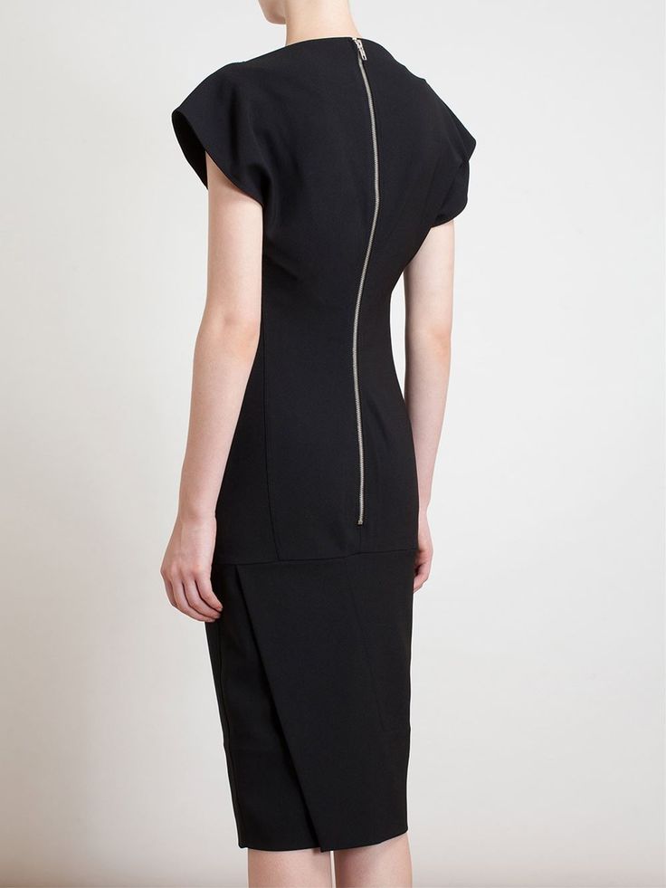 a woman is wearing a black midi sheath dress with a fulllength zipper in the back.
