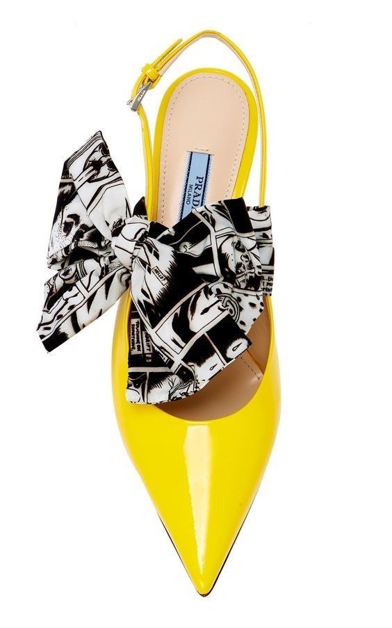 a single yellow prada slingback heel with a black and white graphic ribbon is shown on a white background.