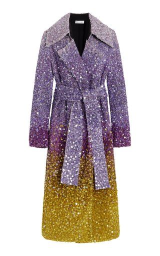 a long, tiebelted women's coat with a sequin design that transitions from purple at the top to gold at the bottom.