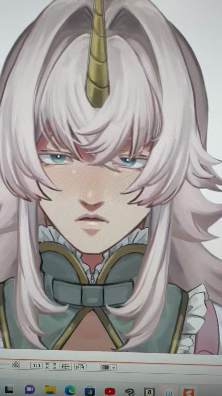 the image shows a digital drawing of an animestyle girl with long white hair and a gold unicorn horn. she has a serious expression on her face.  she is wearing a green and gold collared outfit with ruffles. the image is a closeup of the character's face and upper body, and the art style is quite detailed.  the image appears to be on a computer screen, with some browser icons visible at the bottom.