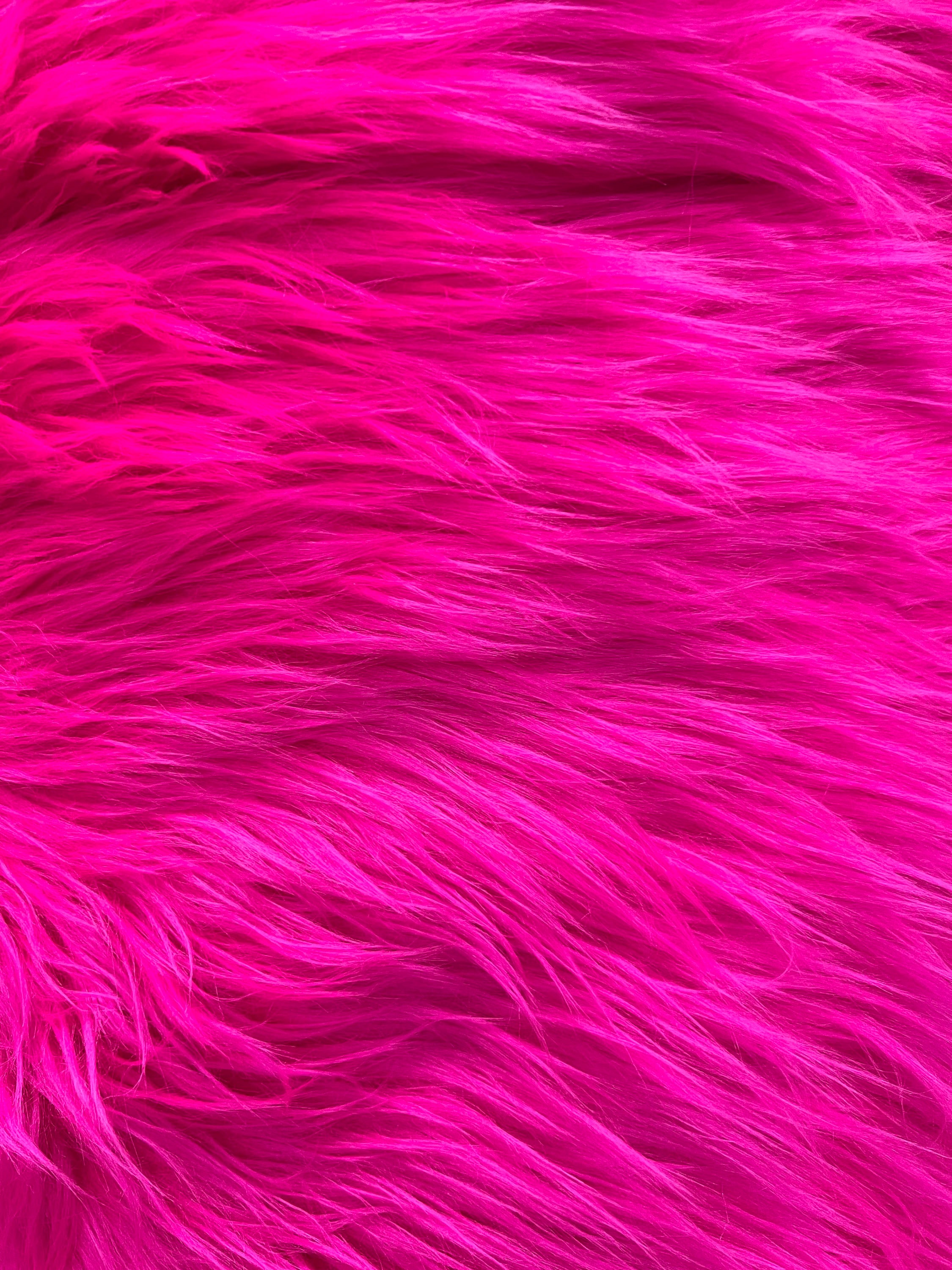 the image shows a closeup view of vibrant pink fur, emphasizing its soft and fluffy texture.  the fur's rich color and texture create an abstract and visually appealing pattern.