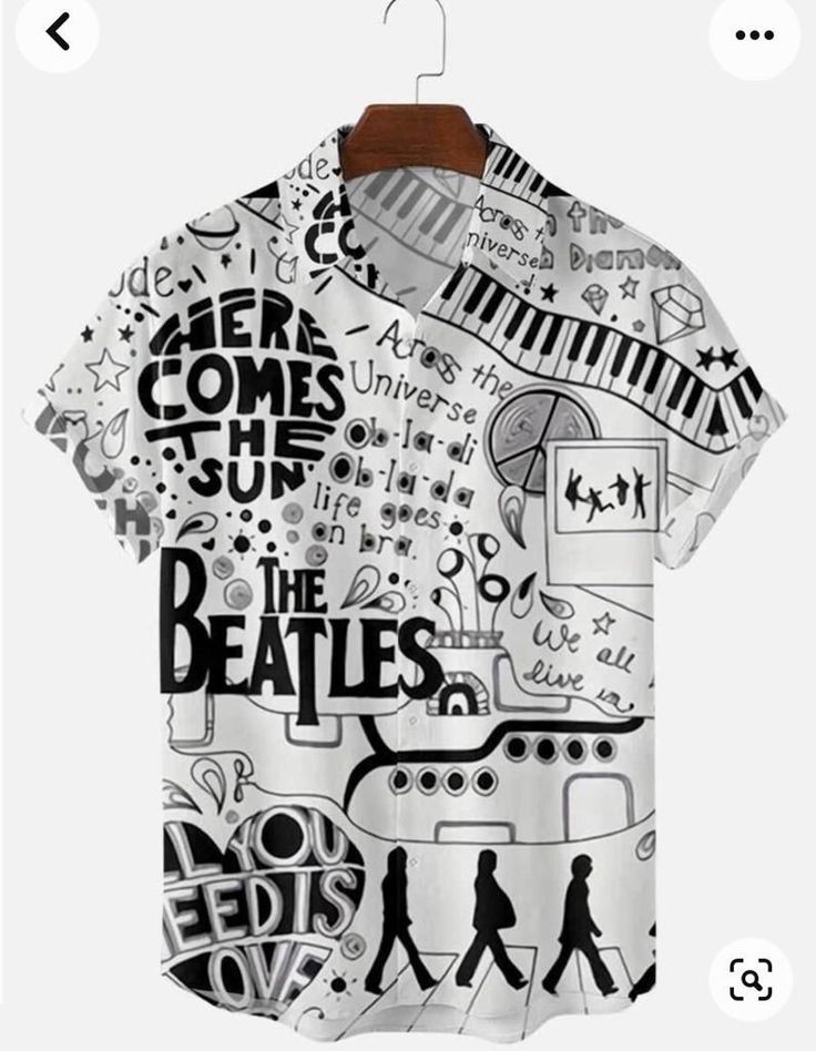 the image shows a white buttonup shortsleeved shirt hanging on a hanger. the shirt has a black and white pattern that includes drawings and phrases related to the beatles, such as "here comes the sun", "the beatles", "across the universe", a keyboard, silhouettes resembling the abbey road album cover, flowers, and the phrase "all you need is love". there are also other doodlelike drawings scattered throughout.