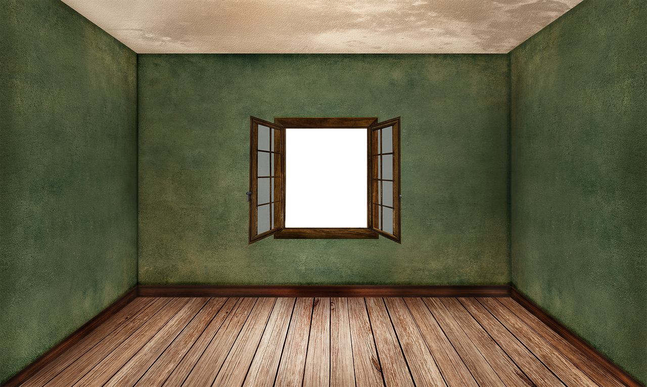 an empty room with green walls and a wooden floor has a dark, open window on the center wall. the room appears to be old and slightly dilapidated.
