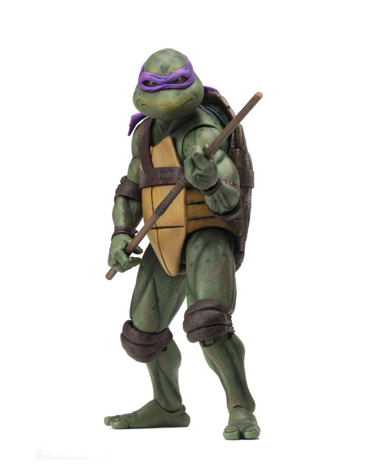an action figure of donatello from the teenage mutant ninja turtles franchise. he is dressed in his signature purple mask and brown/yellow armor. he is holding his bo staff in a ready stance. the action figure is made of plastic and is highly detailed.  the background is white, allowing the figure to stand out.