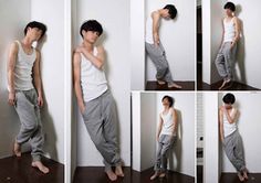 the image shows a collage of seven photos featuring a young man in various poses. he is dressed in a white tank top and gray sweatpants, showcasing different angles and stances against a plain white wall. the minimalist environment and soft lighting emphasize the man's figure and posture.