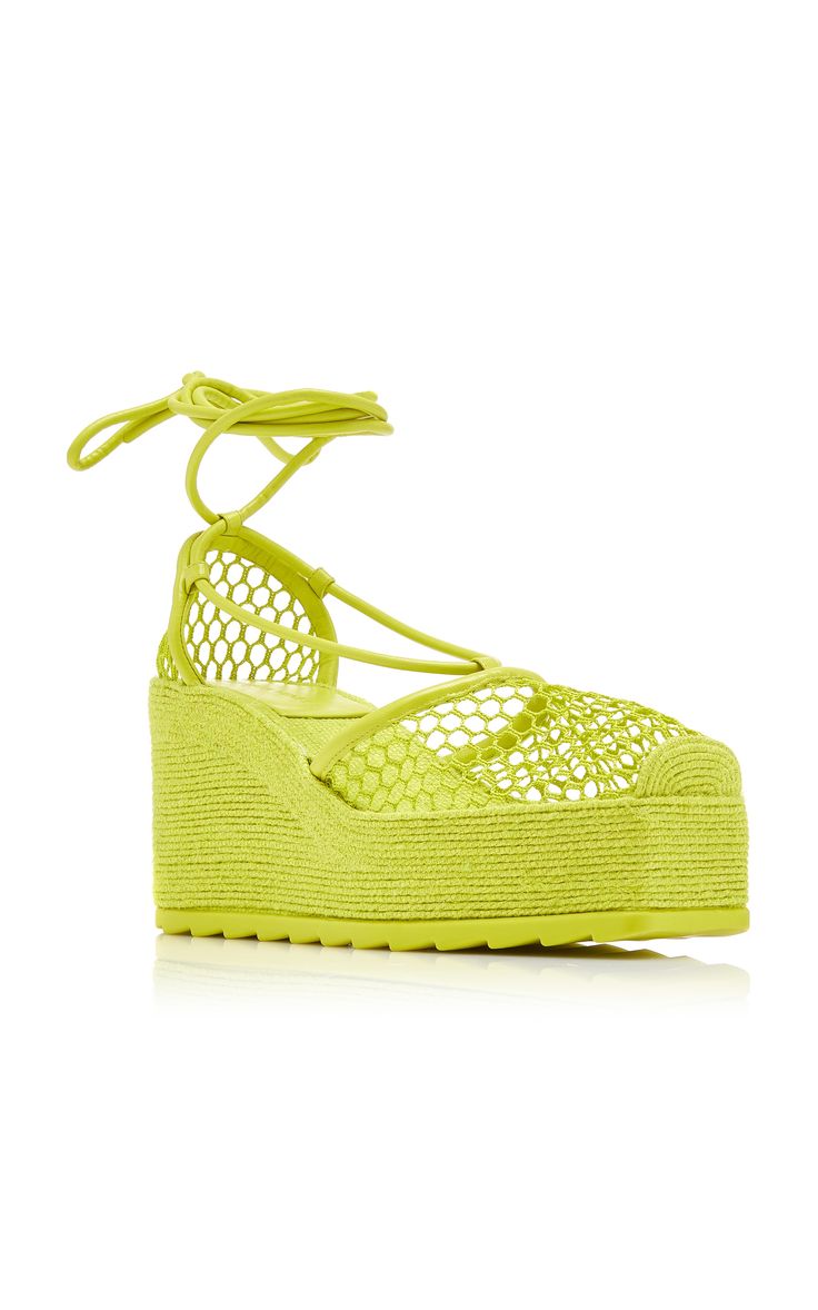 a pair of women's lime green platform espadrille wedges are shown on a white background. the wedges feature a mesh upper with laceup closure and a woven jute platform sole.
