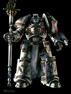 the image showcases a meticulously crafted sculpture of a space marine clad in ornate terminator armor, a staple of the warhammer 40,000 universe. the armor boasts intricate details and a metallic sheen, reflecting the studio lighting. the space marine stands tall, wielding a formidable power weapon. the overall aesthetic exudes power and futuristic warfare.