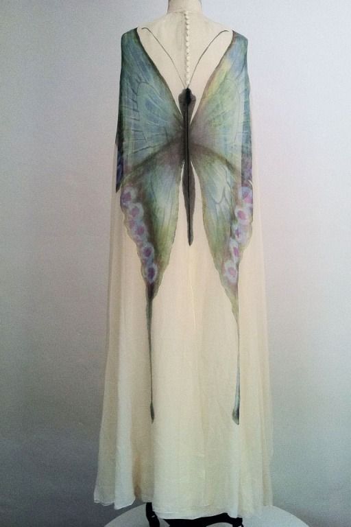 the image shows an ivory dress with a butterfly design on it.