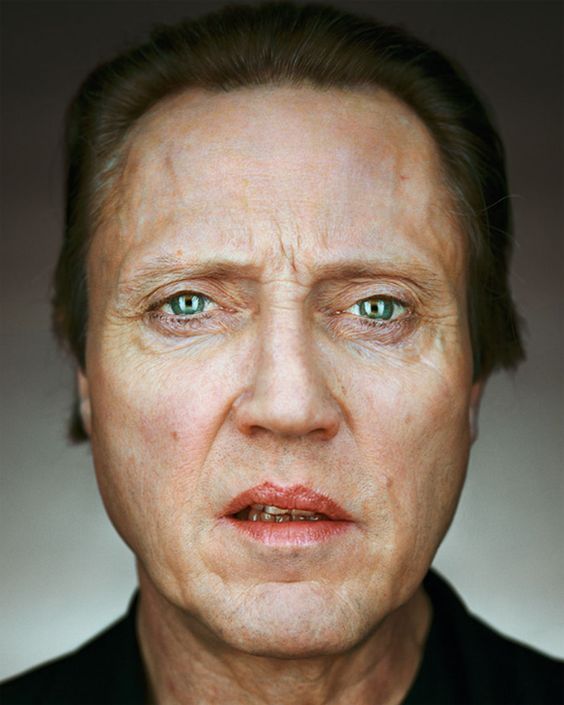 a closeup portrait of actor nicolas cage. he is looking directly at the camera with a serious expression on his face. his green eyes are wide open and his forehead is wrinkled.
