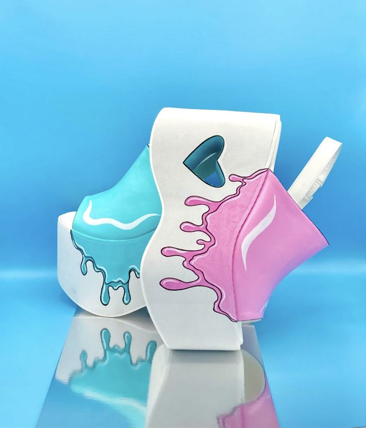 a pair of platform shoes. one shoe is blue with white drips, and the other is white with pink drips. the white shoe also has a heartshaped cutout on the side. they are sitting on a glossy surface that reflects the shoes. the background is a solid light blue. the shoes have a cartoonish style.
