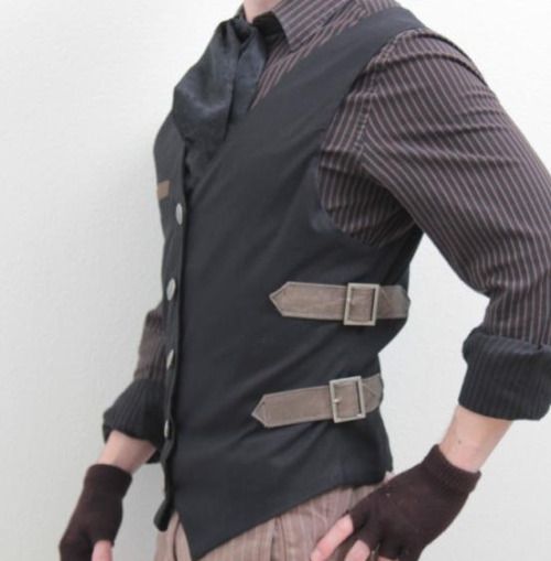 a person wearing a black vest with two light brown buckle straps, a brown striped shirt with rolled up sleeves, a dark brown tie, and dark brown fingerless gloves.