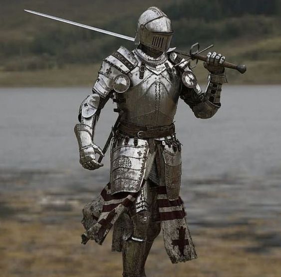 a knight in full plate armor stands in a field with a lake in the background. he holds a sword over his shoulder, its point aimed towards the ground. the knight's armor is highly detailed, showing signs of wear and tear.  his surcoat, tattered and torn, bears a red cross on the front. the image evokes a sense of history, strength, and the weight of battle.