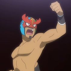 a muscular man with tan skin and black hair is striking a pose. he has on a red, yellow, and blue luchador mask and a black wristband on his right arm. the background is dark.  the lighting is dramatic, coming from above.