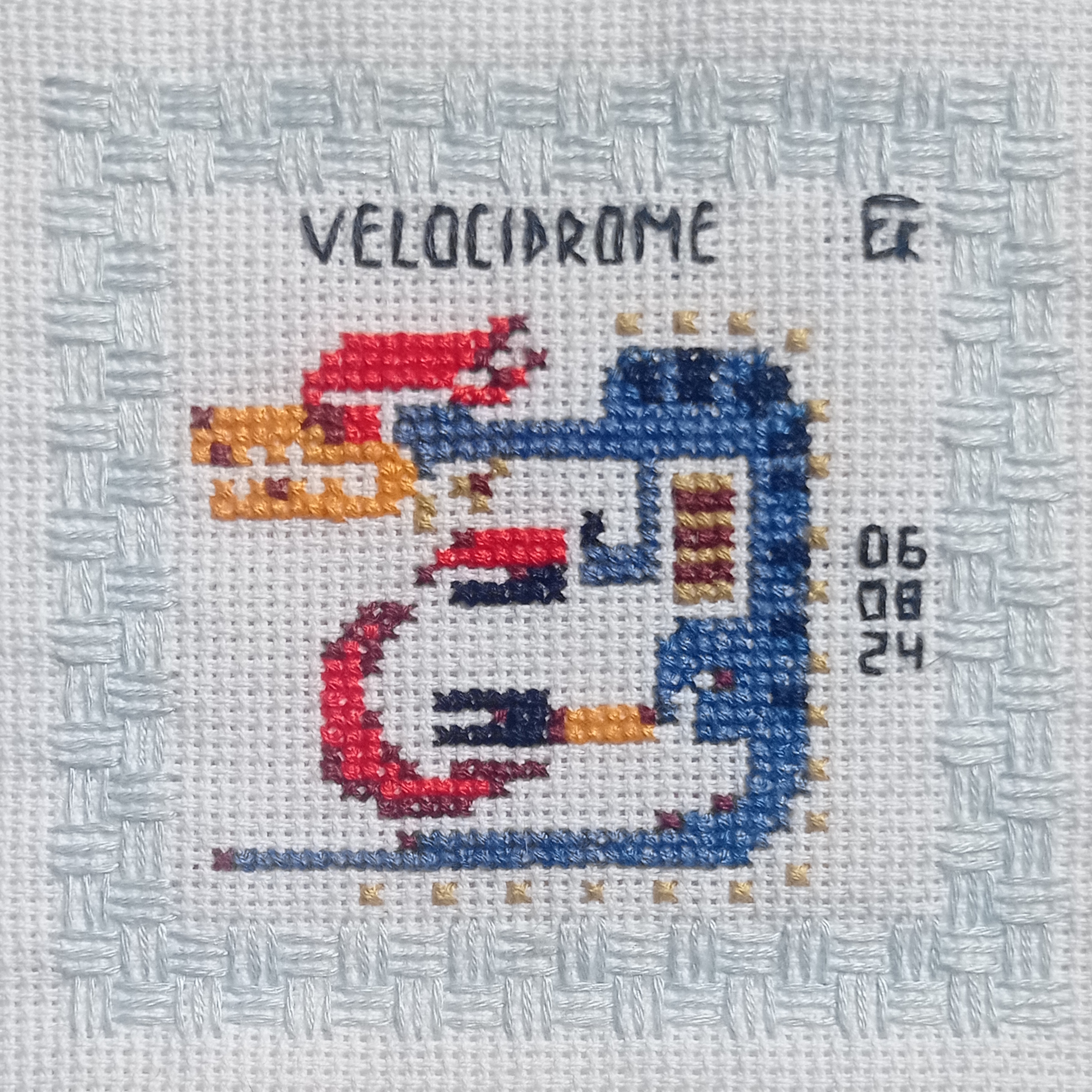 a photograph of a finished piece of needlepoint, framed with a simple border. the needlepoint depicts an abstract design of a blue and red creature, inspired by the movie videodrome, and is dated august 5th, 2024.