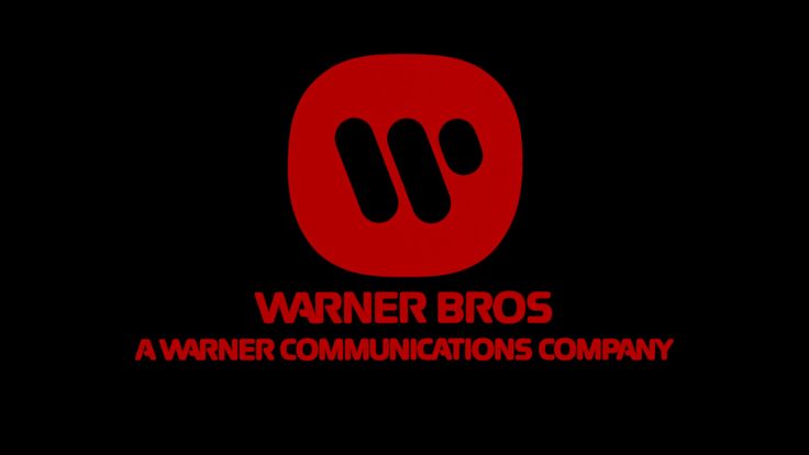 the warner bros logo, in red, on a black background. the logo features the famous "w" with the words "warner bros." and "a warner communications company" below.