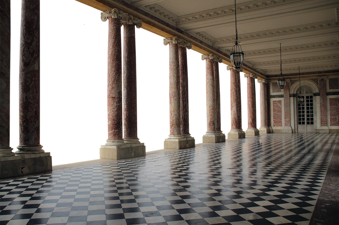 the image shows a long hallway with marble columns and a black and white checkered floor. the columns are spaced evenly along the side of the hallway, and there are chandeliers hanging from the ceiling. it is night outside.