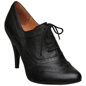 a single black leather highheeled oxford shoe with laces.