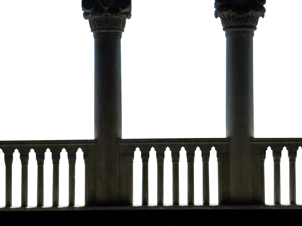 the image shows a stone or marble balustrade with ornate columns against a black background. the balustrade has a classical design with detailed carvings and is made up of many small pillars between larger columns.