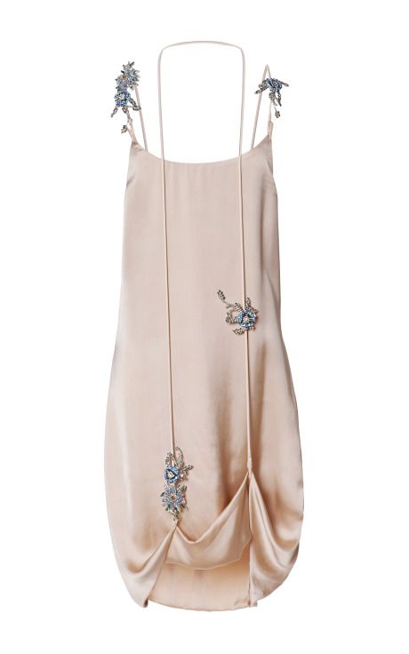 a beige silk slip dress with delicate beadwork in floral designs adorning the straps and body, draped at the bottom.