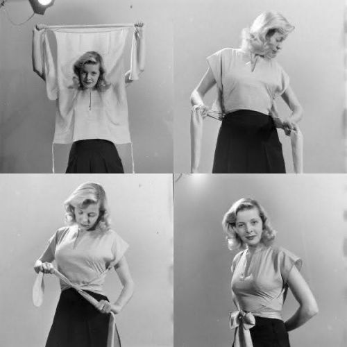 a black and white photo depicting a woman in four different stages of creating a wrap top. the first image shows the woman holding the fabric in front of her, the second shows her wrapping the fabric around her waist, the third shows her tightening the fabric, and the fourth shows the finished wrap top with a bow. the woman is wearing a dark skirt and has blonde hair. the photo appears to be a vintage tutorial or demonstration of how to create this style of top.