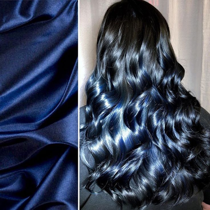 a woman with black hair that has a dark blue tint on the bottom half of her hair. the image is split into two. on the left side is a dark blue silk fabric and on the right side is the woman with her hair. the blue tint in her hair complements the fabric's color. the woman's hair is styled in loose waves and curls.  she is looking stylish and elegant.