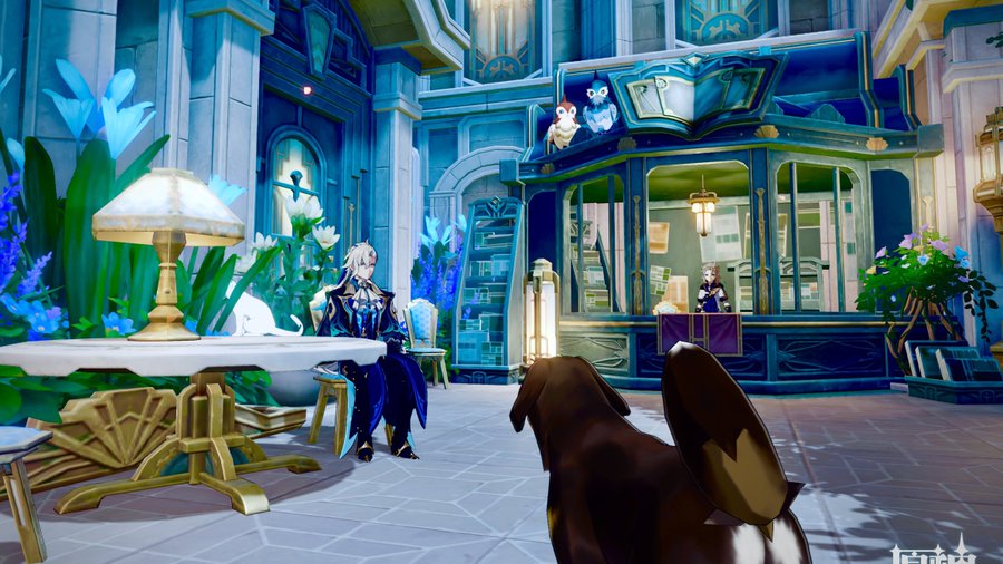 a screenshot from the video game genshin impact shows a scene inside an elegant, fantasy building. the architecture is ornate and features shades of blue, teal, white, and gold. a male character in elaborate clothing sits at a table, accompanied by a small white animal.  a female character is visible behind a counter in a shop filled with books. a doglike creature is in the foreground, looking toward the seated male character. the overall aesthetic is luxurious and magical.  plants and flowers add to the scene's vibrancy.