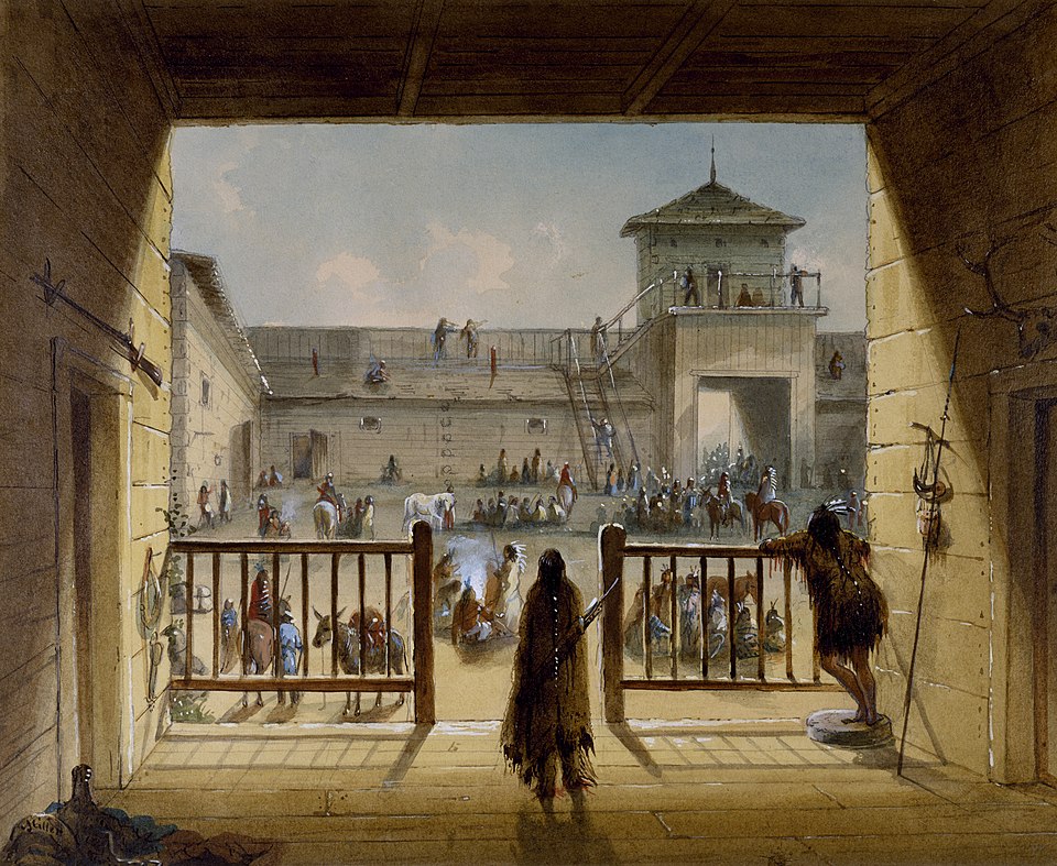 the image depicts a view of a fort courtyard, with indigenous people gathered inside. the perspective is from within a building, looking out through an opening or gate. the courtyard is surrounded by wooden structures, including a guard tower and a wooden palisade. figures on horseback and on foot are visible throughout the courtyard. there is a gathering of native americans. the presence of spears and rifles suggests a possible trade post or military presence. people are present on the roof of one of the buildings.