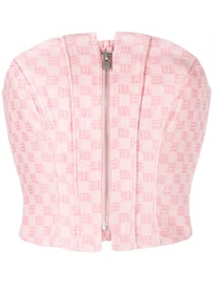 this is a closeup view of a pink strapless corset top. the corset has a zipper down the front and is made of a soft, silky fabric. it is designed to cinch in the waist and give a flattering hourglass figure.