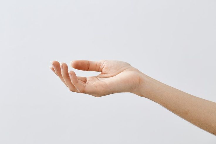 the image features a closeup of a human hand and arm against a light gray background. the hand is open with the palm facing upwards and fingers slightly curved. the skin is smooth and appears to be welllit. the arm extends away from the hand, receding into the background.