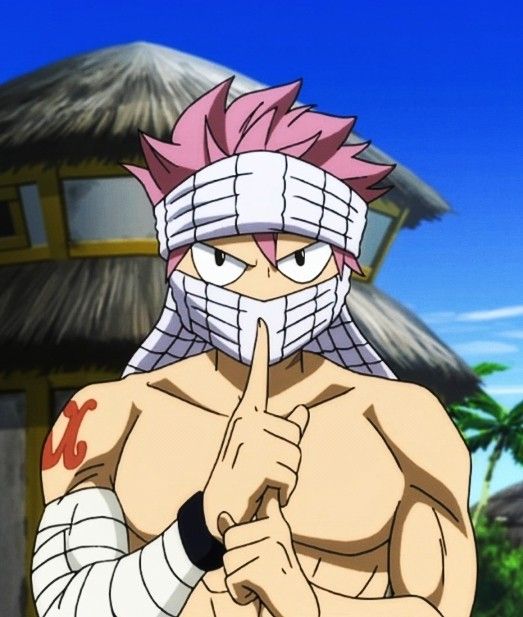 the image showcases a digital illustration of natsu dragneel, a popular character from the anime and manga series "fairy tail." he is depicted outdoors on a sunny day, standing in front of a beach hut. natsu's pink hair is partially concealed by a white headband, and his lower face is covered with bandages. he is shirtless, revealing a muscular physique with bandages wrapped around his arms. his expression is serious, and he holds a finger to his lips in a "shushing" gesture. the bright lighting and vibrant colors enhance the dynamic and eyecatching nature of the illustration.