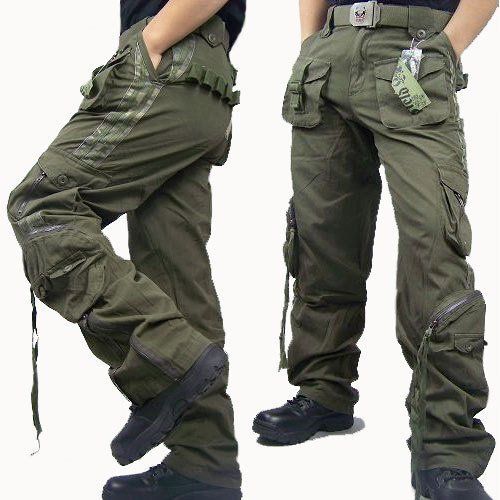two men are wearing green cargo pants and boots. they are standing side by side and looking at the camera. the pants have a lot of pockets and a camouflage design. they are wearing casual shoes and have an overall military look. the picture is taken from the waist up and is focused on the pants and shoes.