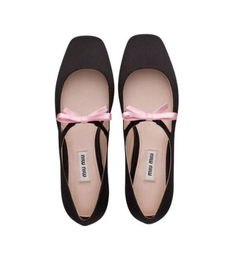 a pair of black satin miu miu ballerina flats with a delicate pink bow are displayed against a white background.  the shoes are positioned slightly apart, showing the details of the design and the brand label inside. the overall impression is one of feminine elegance and sophistication.