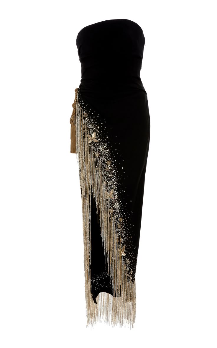 a strapless, floorlength black dress is shown against a white background. the dress is fitted at the top and flows down into a skirt. it features detailed beadwork and silver fringe along the side.