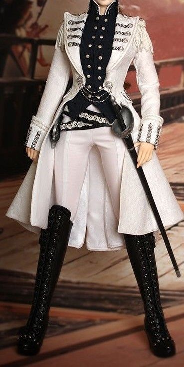 a doll in a white military inspired jacket and black pants, poses for the camera. the doll has black boots on and is holding a silver sword in one hand. the jacket is lined with silver buttons. the background is a blurry shot of a wooden floor.