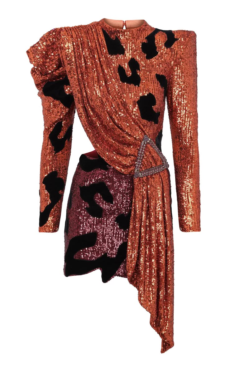 a shimmering, coppertoned dress is the main subject, adorned with black leopardlike spots. the dress features long sleeves and a unique draped design on the front, cinched together by a triangle buckle.