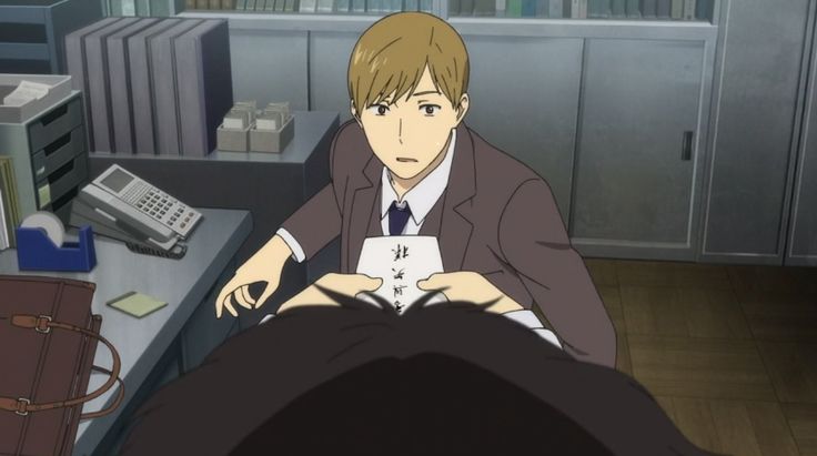 a man in a suit, standing in an office, looking down at another man with black hair. the man in the suit appears to be speaking to the blackhaired man. there is a desk behind the suited man, with a phone and other office supplies on it. there are file cabinets in the background. the man in the suit is holding a piece of paper with japanese writing on it.