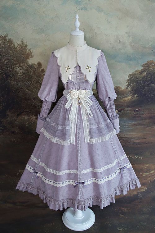 a fulllength image of a purple victorianstyle dress on a mannequin. the dress features a square neckline, long sleeves with puff shoulders, and a full skirt with layers of lace and ruffles. the dress is adorned with white floral embroidery and comes with a matching detachable collar. the background of the image is a painting of a landscape.