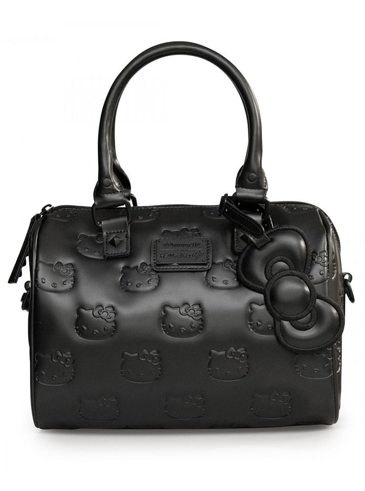 a black hello kitty handbag with hello kitty faces embossed across the body and a large hello kitty bow charm hanging from the handle. the bag has a glossy, vinyllike appearance.