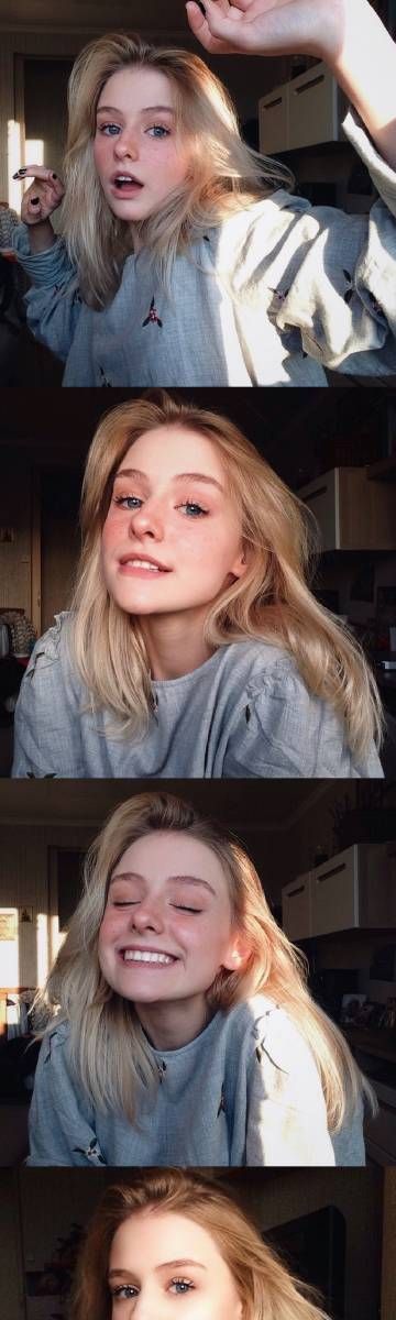 a blonde woman in a grey sweater is smiling at the camera in four different photos. she has blonde hair that is parted in the middle and falls down her shoulders.  she is wearing a grey sweater that has a light shining through it.  she is looking at the camera with a bright smile on her face.  she is in an indoor setting, but the sun is shining through the window.