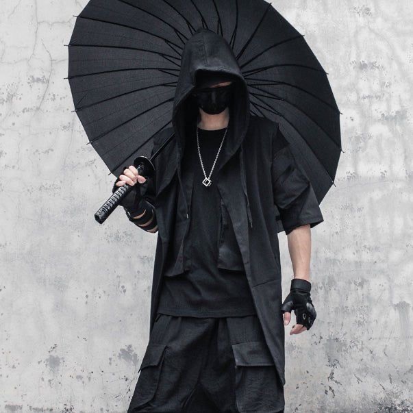 a man in a black hooded jacket, black pants, and black gloves holds a katana sword under a large black umbrella. he looks mysterious and stylish. his outfit is dark, edgy, and futuristic. he might be a ninja or samurai. his style is urban streetwear.