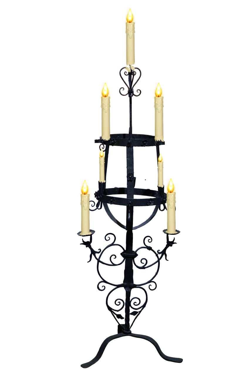 a wrought iron candelabra stands tall against a solid black background. it features several arms and levels designed to hold candles, each of which is lit. the candelabra is intricately designed with curved elements and a decorative, ornate style. the black background emphasizes the shape and light of the candelabra.