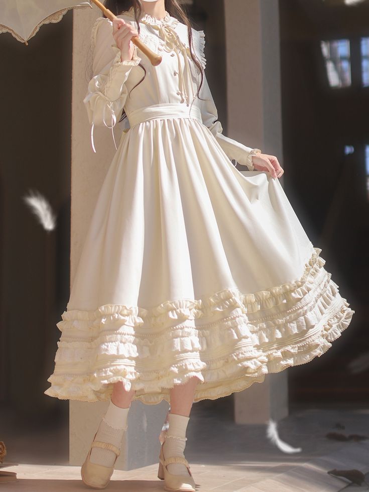 a woman stands elegantly in a sunlit space, wearing a long, flowing white dress. the dress features intricate lace detailing, delicate ruffles, and a high collar. she holds a white parasol, adding to the vintage aesthetic. soft, natural light bathes the scene, creating a dreamy atmosphere. feathers scattered around her feet add a whimsical touch.